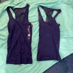 two so blue tank tops. one brand new with tags. one medium one small
